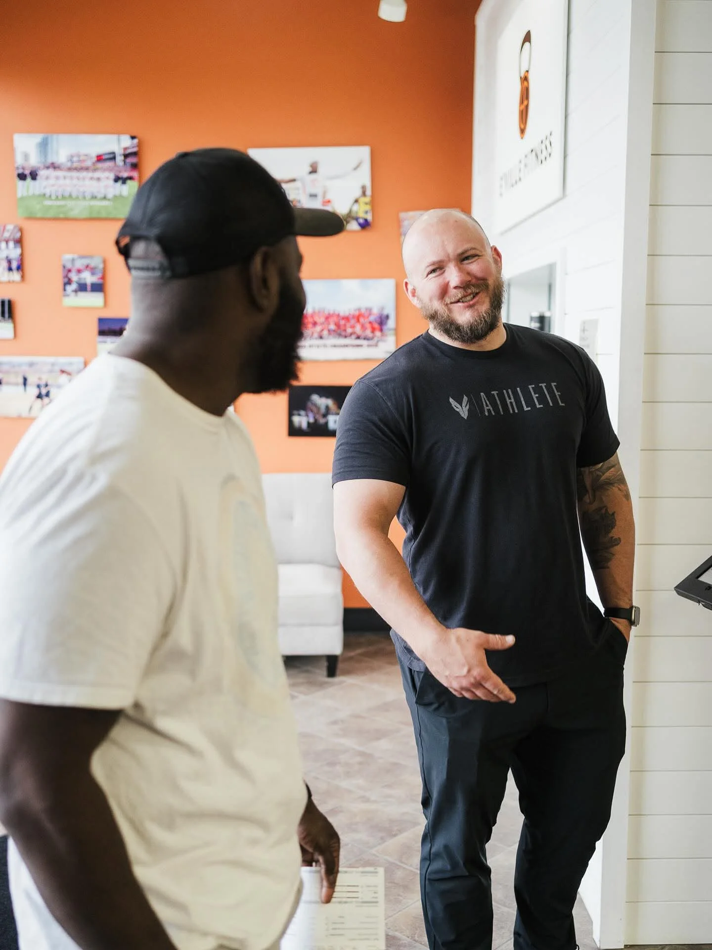 Members talking on the floor at E’ville Fitness