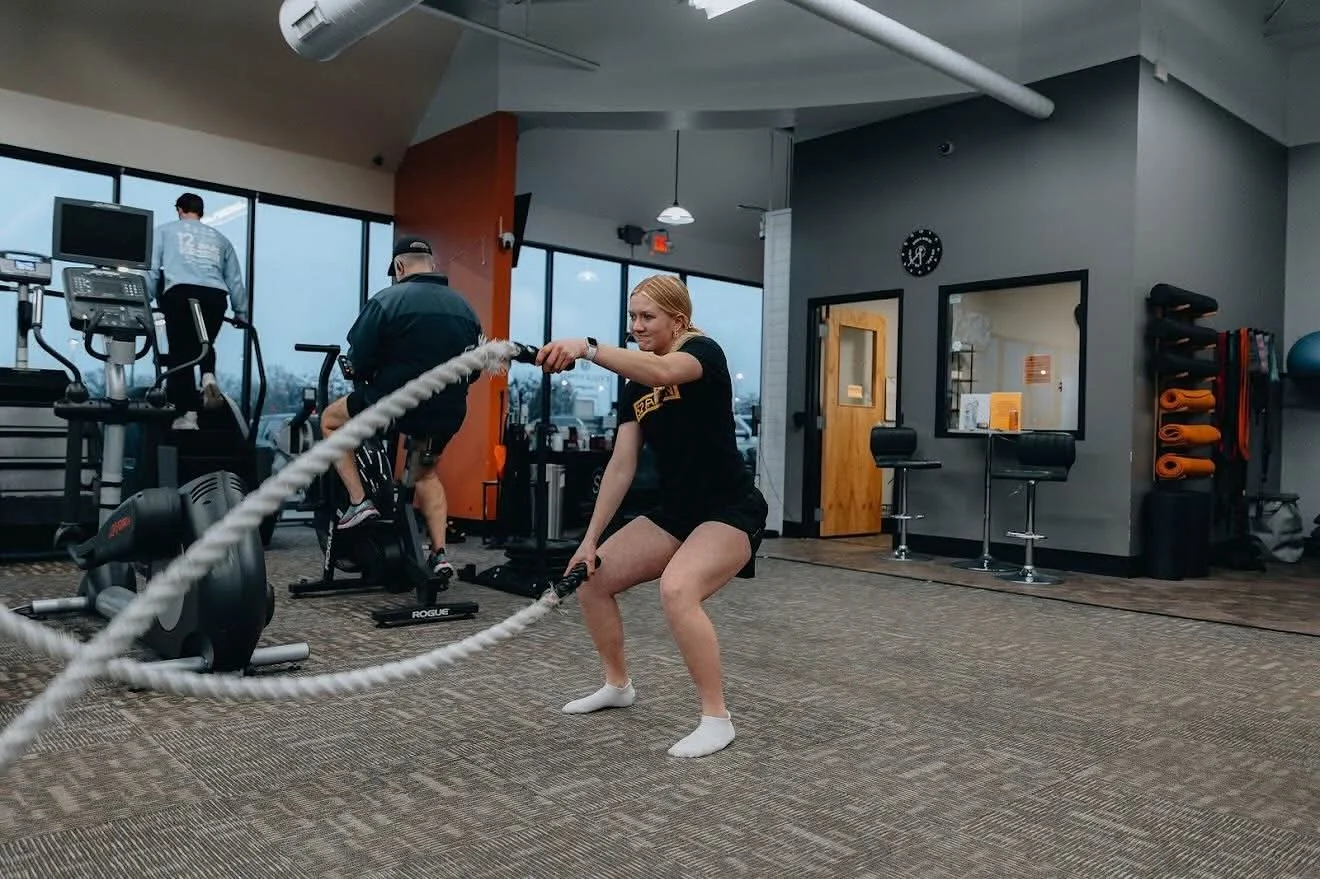 Member working battle ropes at E’ville Fitness
