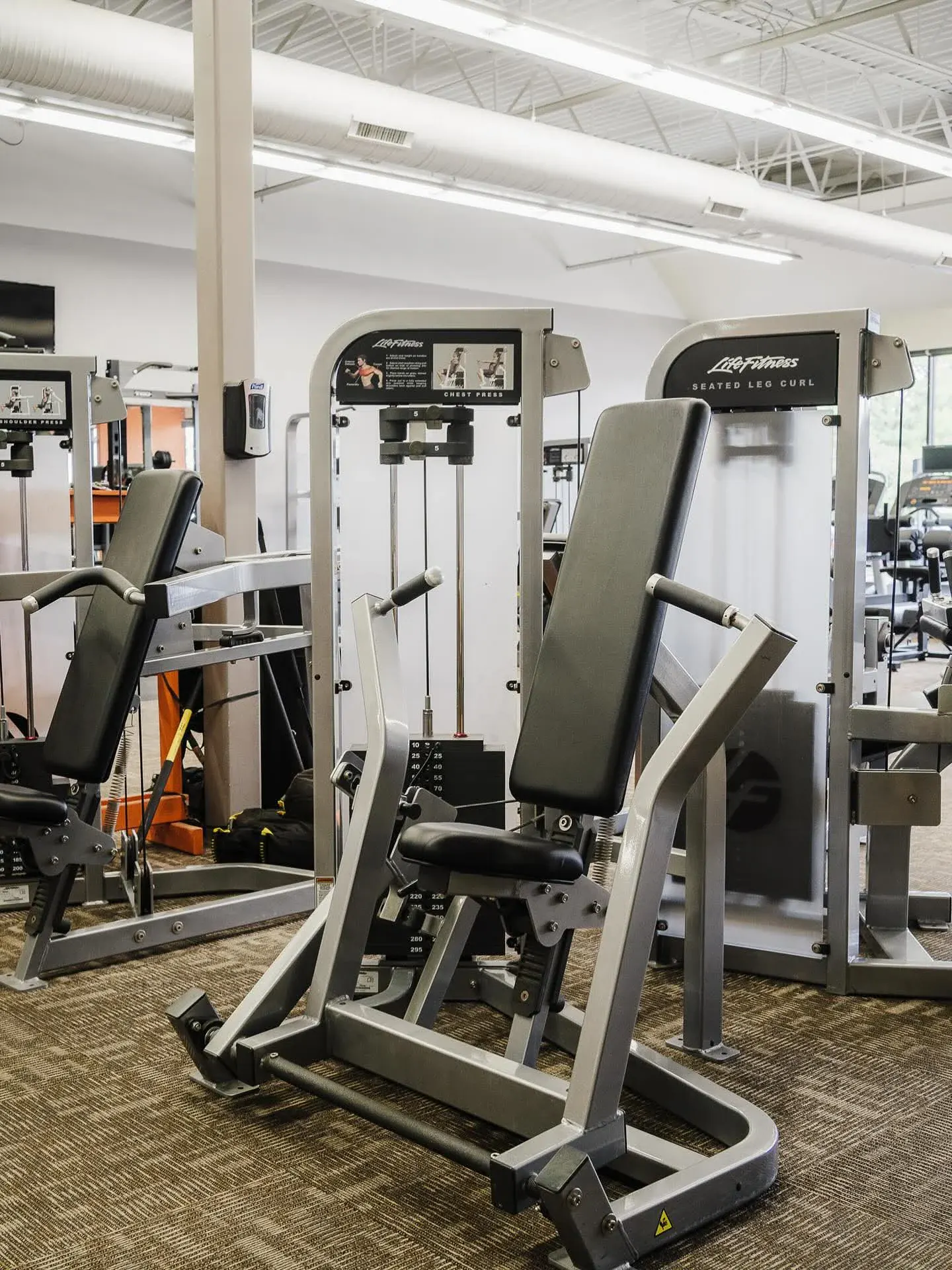 Member pressing on chest day at E’ville Fitness