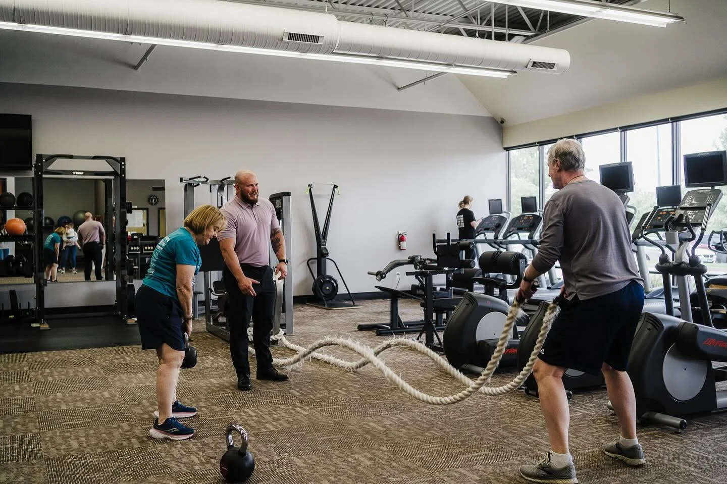 Members of every age training together with coaches on the E’ville Fitness floor