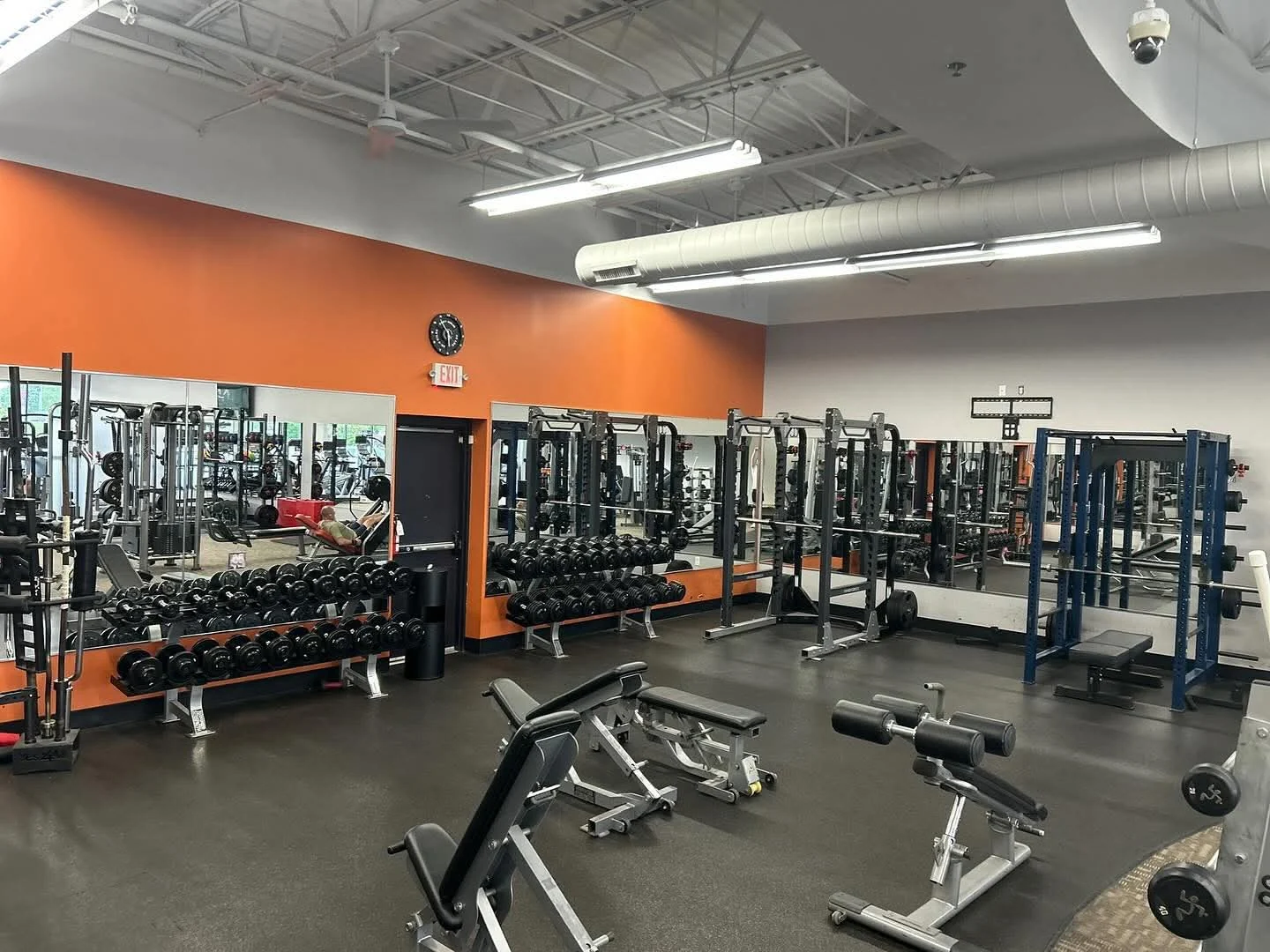 Clean strength floor with dumbbell racks and benches at E’ville Fitness